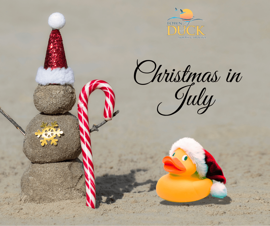 Christmas in July graphic with a sand Santa holding a candy cane and rubber duck with santa hat