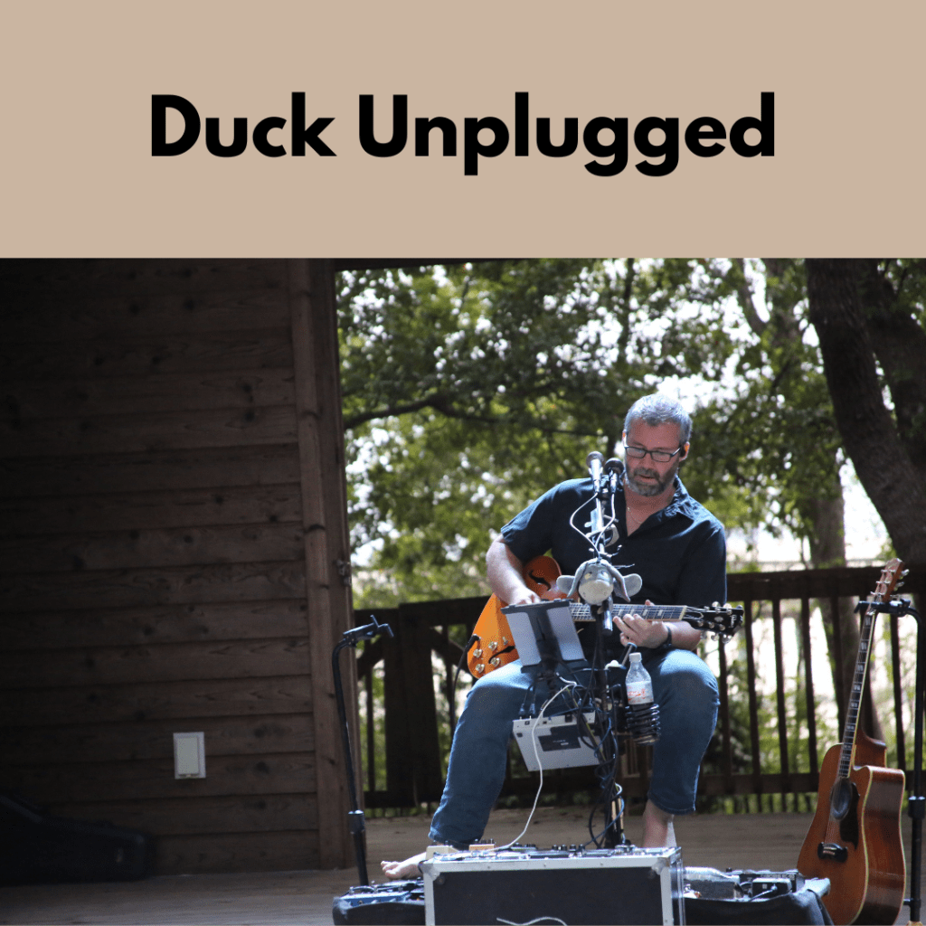 Duck Unplugged with Phil Watson playing on a stage